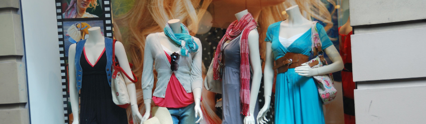 dressed female fiberglass mannequins decorating store window